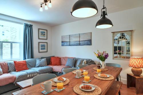 a living room with a couch and a table at Finest Retreats - Woodleigh, Cawsand in Cawsand
