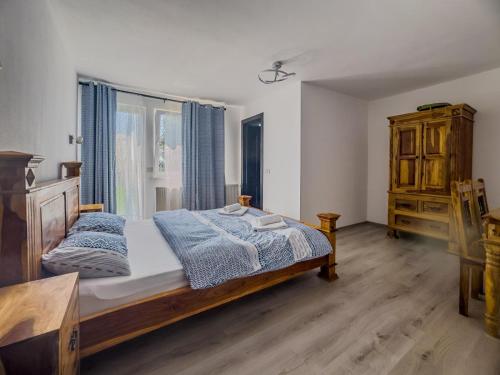 a bedroom with a bed and a large window at Casa Luna Șirnea in Şirnea