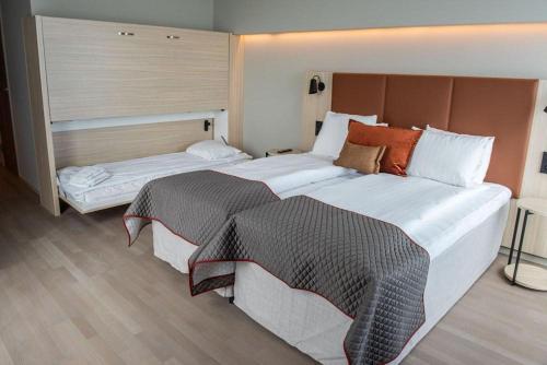 a hotel room with two beds and a window at Quality Hotel Arlanda XPO in Arlanda