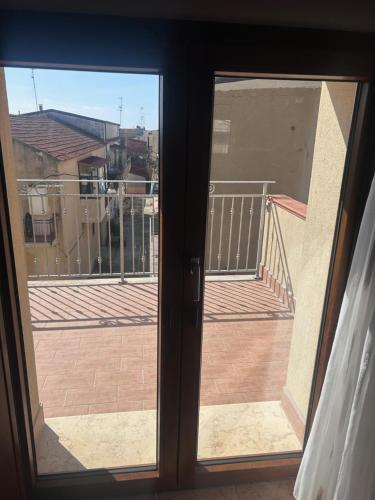 a sliding glass door with a view of a balcony at L'antico Orologio in Isola Capo Rizzuto