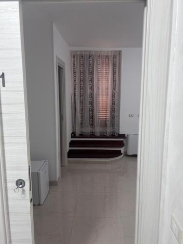 a hallway with stairs and a window in a building at L'antico Orologio in Isola Capo Rizzuto