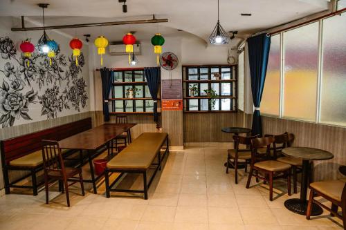 a restaurant with wooden tables and chairs and lights at Kim Thuy Hotel in Can Tho