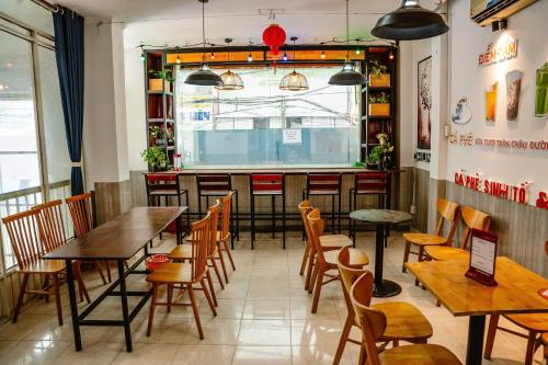 a restaurant with tables and chairs and a window at Kim Thuy Hotel in Can Tho