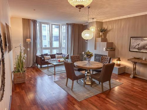 a living room with a table and chairs and a couch at Kastell3 Boutique Apartments in Moers