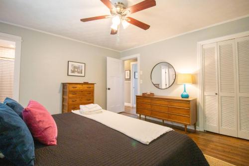 a bedroom with a ceiling fan and a dresser at GVL getaway near Paris Mtn, minutes from downtown in Greenville