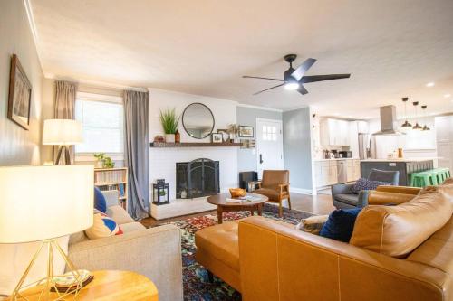 a living room with a couch and a fireplace at GVL getaway near Paris Mtn, minutes from downtown in Greenville