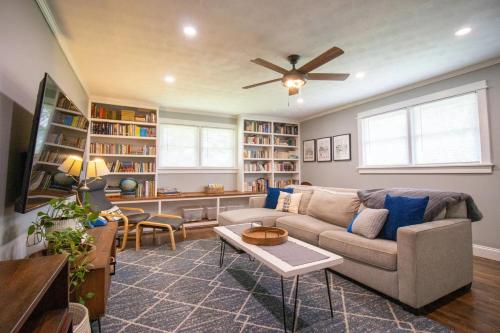 a living room with a couch and a ceiling fan at GVL getaway near Paris Mtn, minutes from downtown in Greenville