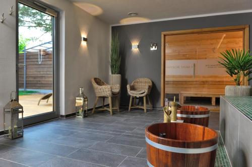 a restaurant with a bar with chairs and a table at Landhotel Schnuck in Schneverdingen