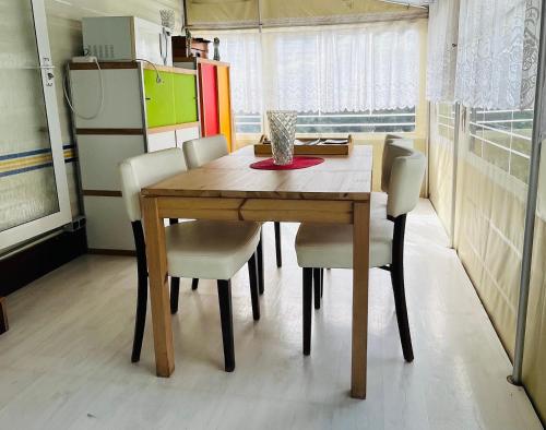 a dining room table and chairs in a room at Caravane en pleine nature ferme proche de tout in Philippeville