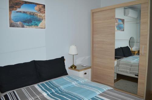 a bedroom with a bed and a large closet at Cozy apartment for overnight stays Hristo Smirnenski in Plovdiv