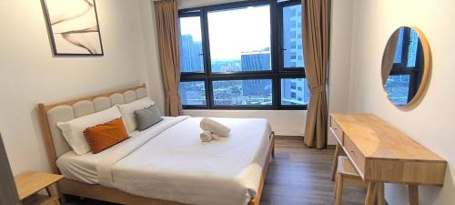 a bedroom with a bed and a desk and a window at Service Apartment Agile Residence KL in Kuala Lumpur
