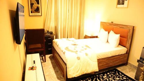 a hotel room with a bed and a television at De GraceManuel Terrace 