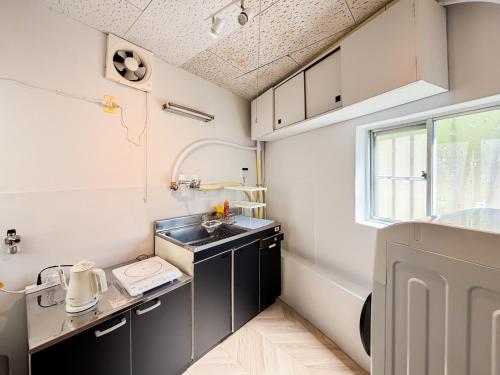 a small kitchen with a sink and a window at BUSHIDO Kinugawa -Nikko-Tochigi in Nikko