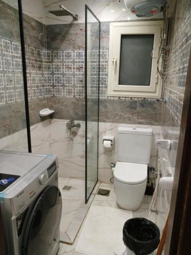 a bathroom with a toilet and a sink and a shower at Grand Luxury Apartments - Downtown Cairo in Cairo