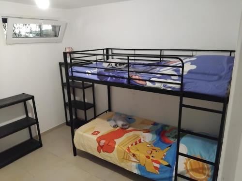 two bunk beds in a small room with a bed at appartement gites a la ferme in Barbentane
