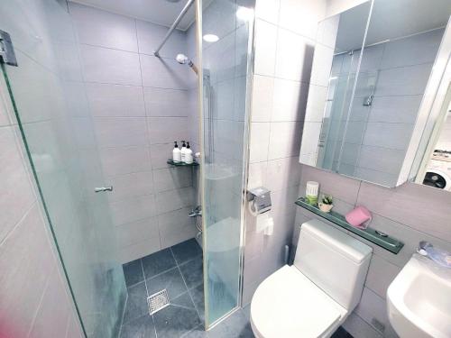 a bathroom with a shower and a toilet and a sink at Like U Residence in Goyang