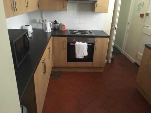 a kitchen with a stove with a towel on the oven at Four Seasons Budget in Aberystwyth