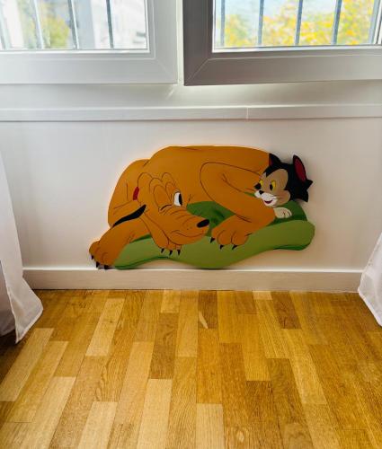 a bed in a corner of a room with two cats on it at THE ENCHANTED HOUSE ( 15 min walk to Disney) in Serris