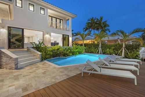 a villa with a swimming pool and a house at Villa Sienna Coastal Warmth in Hollywood