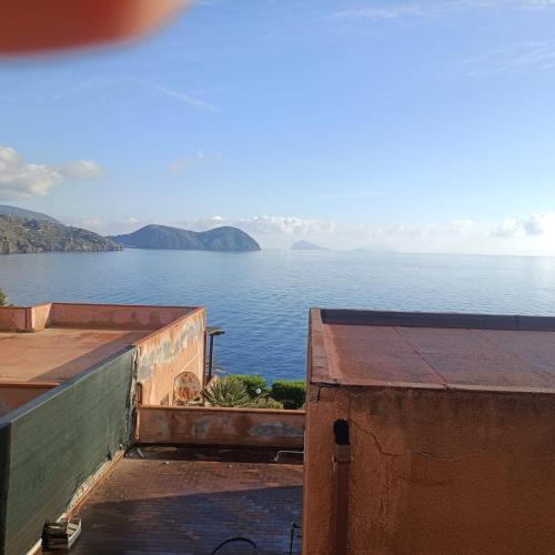 a view of the water from a building at Vulcanello Sea View Apartment in La Fabbrica