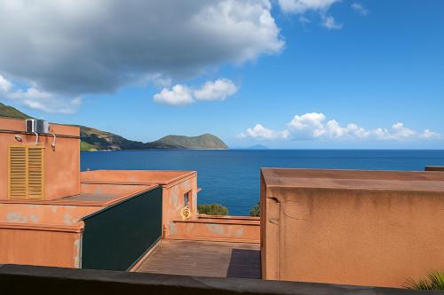 a view of the ocean from the balcony of a building at Vulcanello Sea View Apartment in La Fabbrica