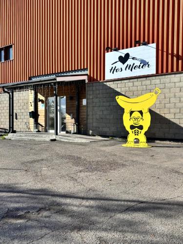 a large yellow statue in front of a building at Frost Longstay Lakeside in Kiruna