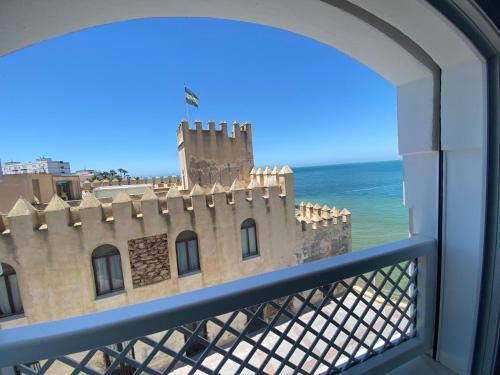 a view of a castle from a balcony at Hotel La Española in Chipiona