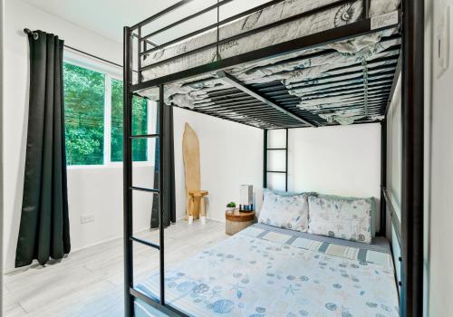a bedroom with a bunk bed in a house at Ocean View Agat Marina Private Accommodation in Agat