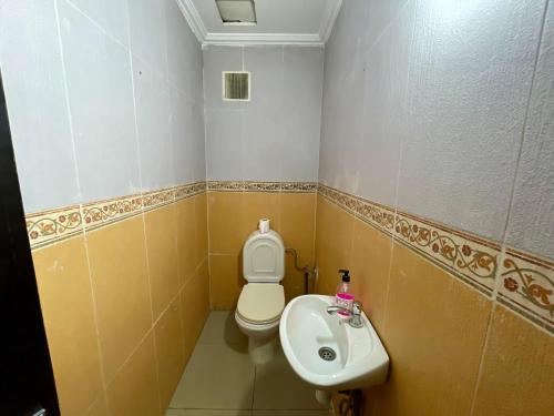 a bathroom with a toilet and a sink at Luxury appartement centre ville Fes - French Touch in Fès