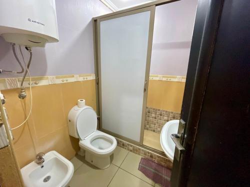 a bathroom with a toilet and a sink at Luxury appartement centre ville Fes - French Touch in Fès