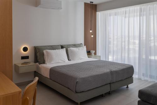 a bedroom with a large bed and a window at Divel Luxury Villas with heated pools, by Estia in Anissaras