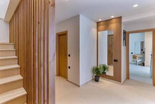 a hallway of a house with stairs and a plant at Divel Luxury Villas with heated pools, by Estia in Anissaras