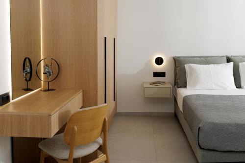 a bedroom with a bed and a desk with a chair at Divel Luxury Villas with heated pools, by Estia in Anissaras