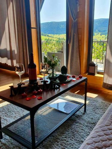 a living room with a table with wine glasses at Villa Merima Vlasic in Vlasic