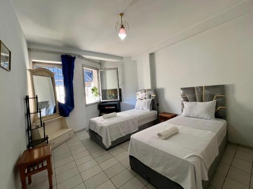 a hotel room with two beds and a mirror at Luxury apartment Fes centre ville - Family & Friendly in Fès