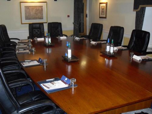 a room filled with chairs and a table at The Grange Manor in Grangemouth