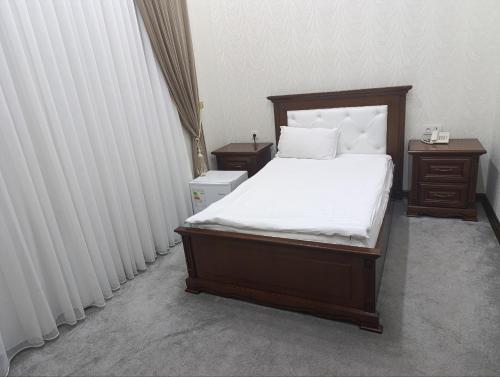 Ένα ή περισσότερα κρεβάτια σε δωμάτιο στο Hayot Hotel Skazka