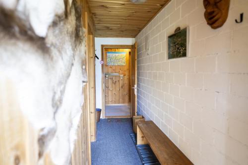 a hallway of a house with a wooden door at Chasa Ulrica in Ftan
