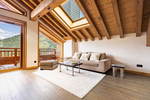 a living room with a couch and a table at Chalets Killington #4 - 4 guests in Les Allues