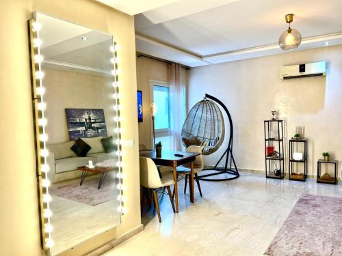 a living room with a table and a couch at Apartment Casa Marina - Borgone, Ocean & Hassan II Views in Casablanca
