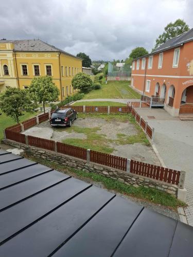 a car parked in a parking lot next to buildings at Penzion U školy in Staré Město
