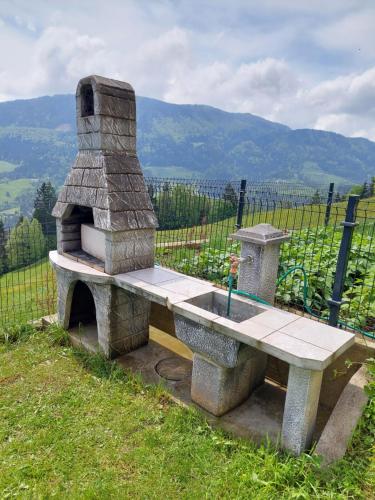 a stone bench sitting on top of a hill at Sunflower House with Jacuzzy and Sauna in Vitanje