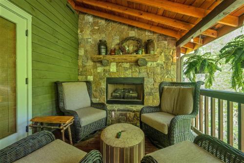 a porch with two chairs and a fireplace at 5br Waterfront Creek Home Hot Tub & Views in McCaysville