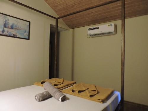 a room with a bed with a wooden tray on it at Abba's Glory Land - Agonda in Agonda