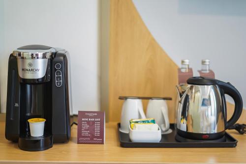 a coffeemaker and a coffee maker on a counter at Truntum Cihampelas in Bandung