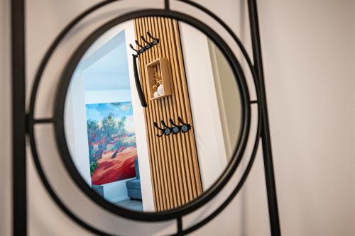 a mirror with a reflection of a room at EHM Elegantes Design Apartment zwischen Linz&Wels in Pucking