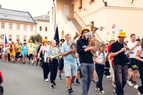 a group of people walking down a street with instruments at Penzion U školy in Staré Město