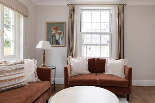 a living room with a couch and a window at Lyminster Court Cottages in Lyminster