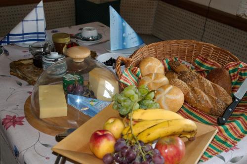 a table with a basket of bread and fruit at Landhaus Greiderer in Kössen