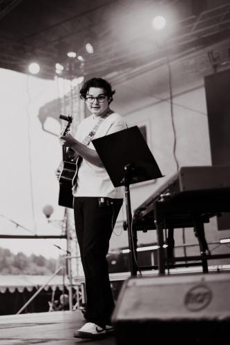 a woman standing on a stage with a instrument at Penzion U školy in Staré Město